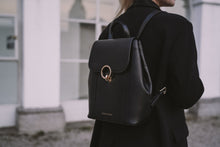 Load image into Gallery viewer, A Lady walking with a black leather backpack from Cocoona